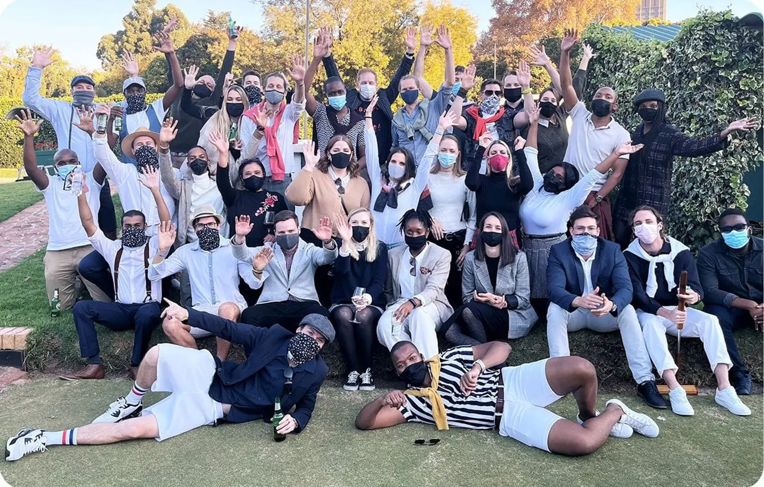 Group photo of Naked employees outdoors.